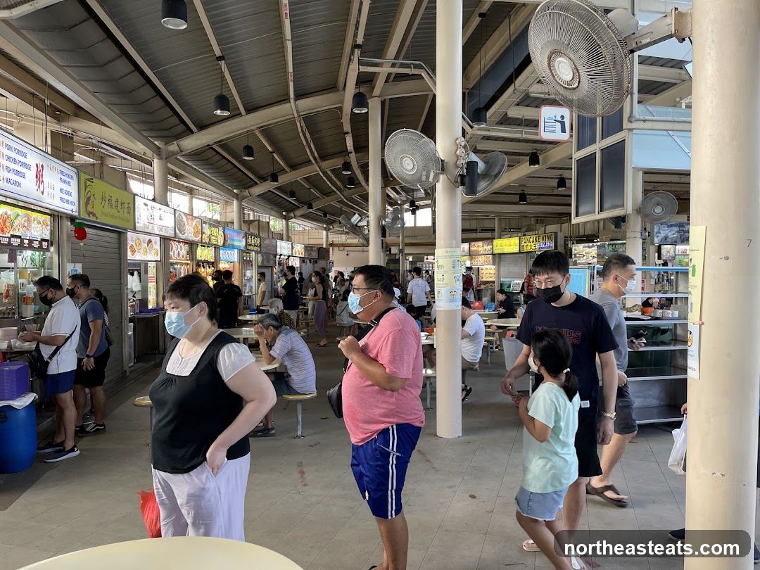 Food court with people dining and queuing