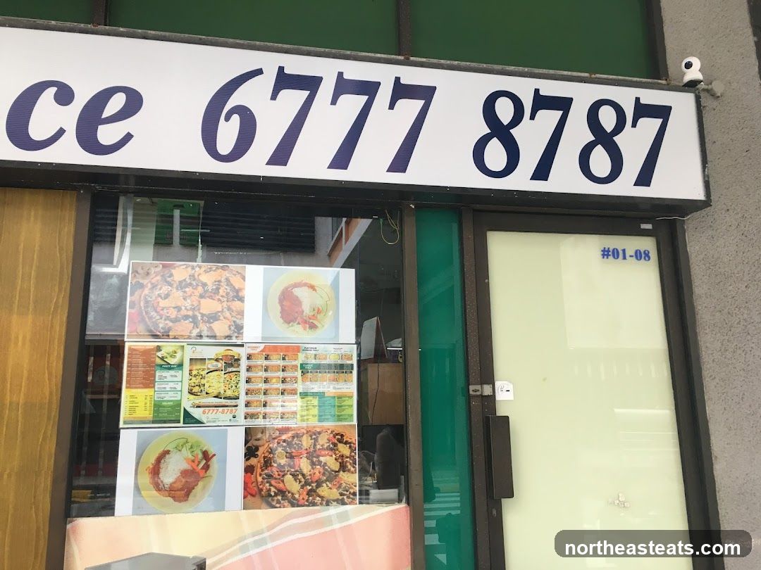 A storefront with a large sign displaying a phone number. Below the sign, there are several framed pictures of food items and menus displayed in the window. The door is to the right of the window display.