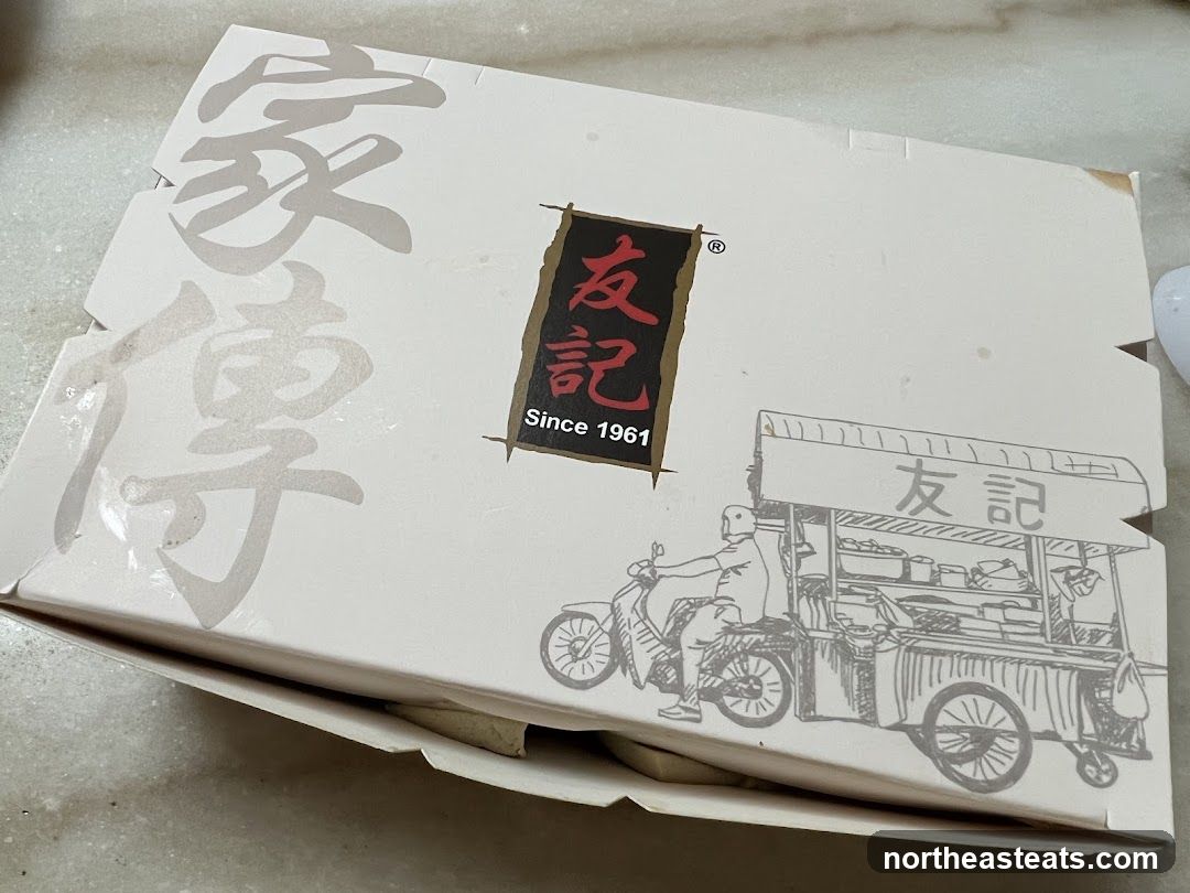 Food packaging with Chinese characters and a drawing of a food cart