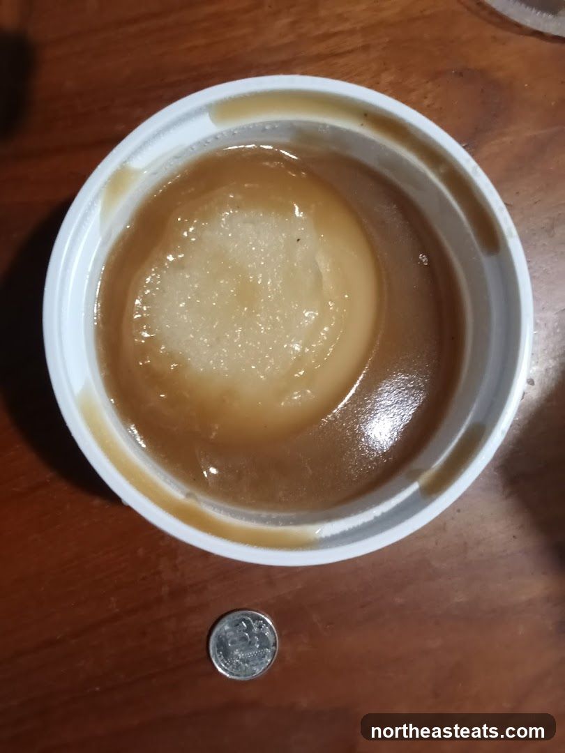 Gravy in a container with a coin for scale