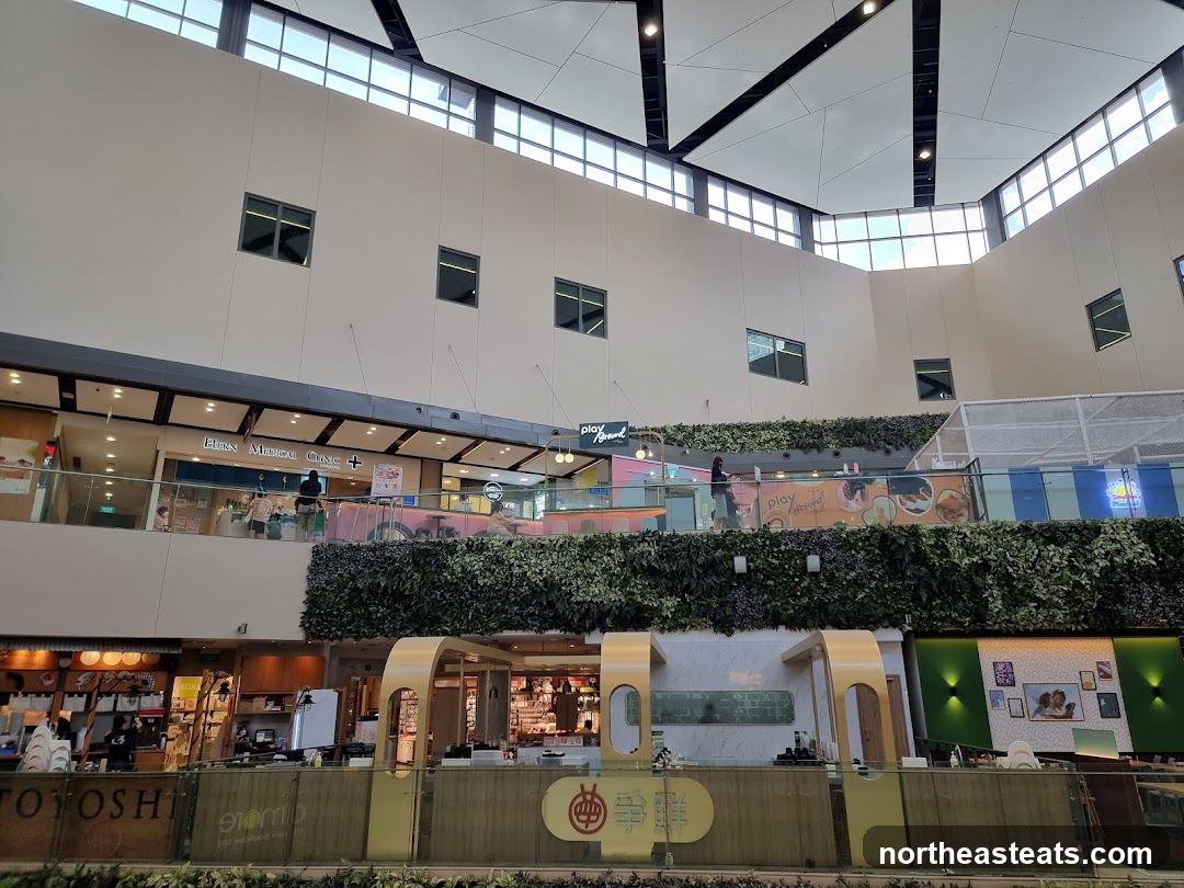 Indoor shopping mall atrium with greenery