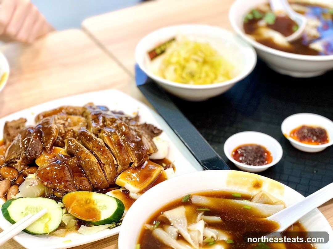 Slices of braised meat with rice noodles and side dishes