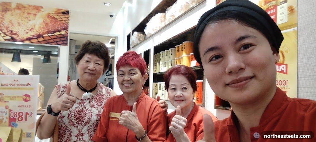 Staff and customers posing for a photo
