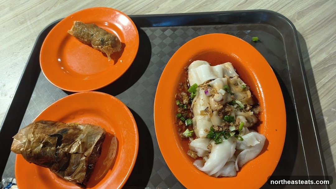 Food on orange plates on a tray