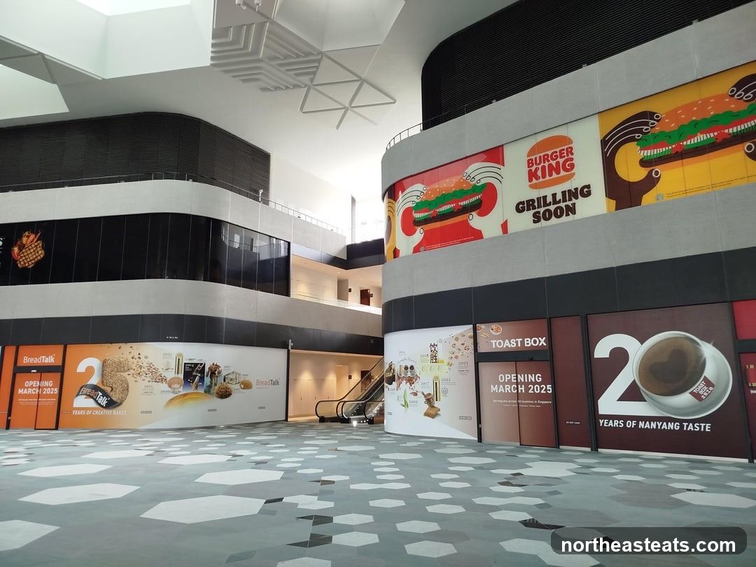 Mall interior with advertisements for upcoming food establishments
