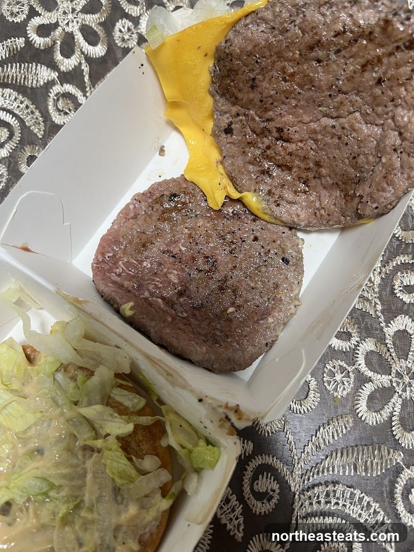 Two beef patties with cheese and lettuce