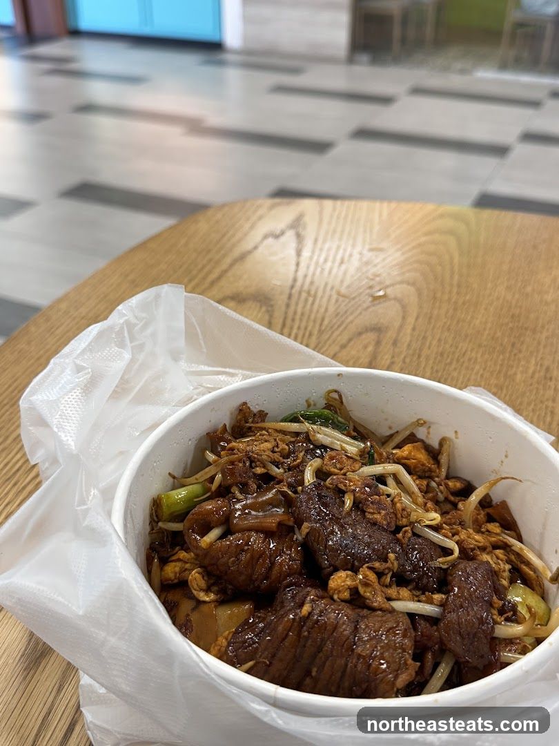 Beef noodle dish in a takeout container
