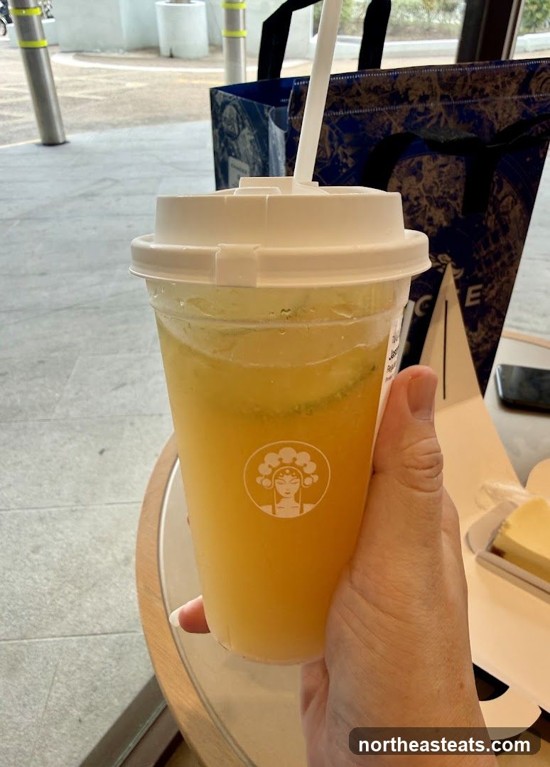 Hand holding a beverage with a logo