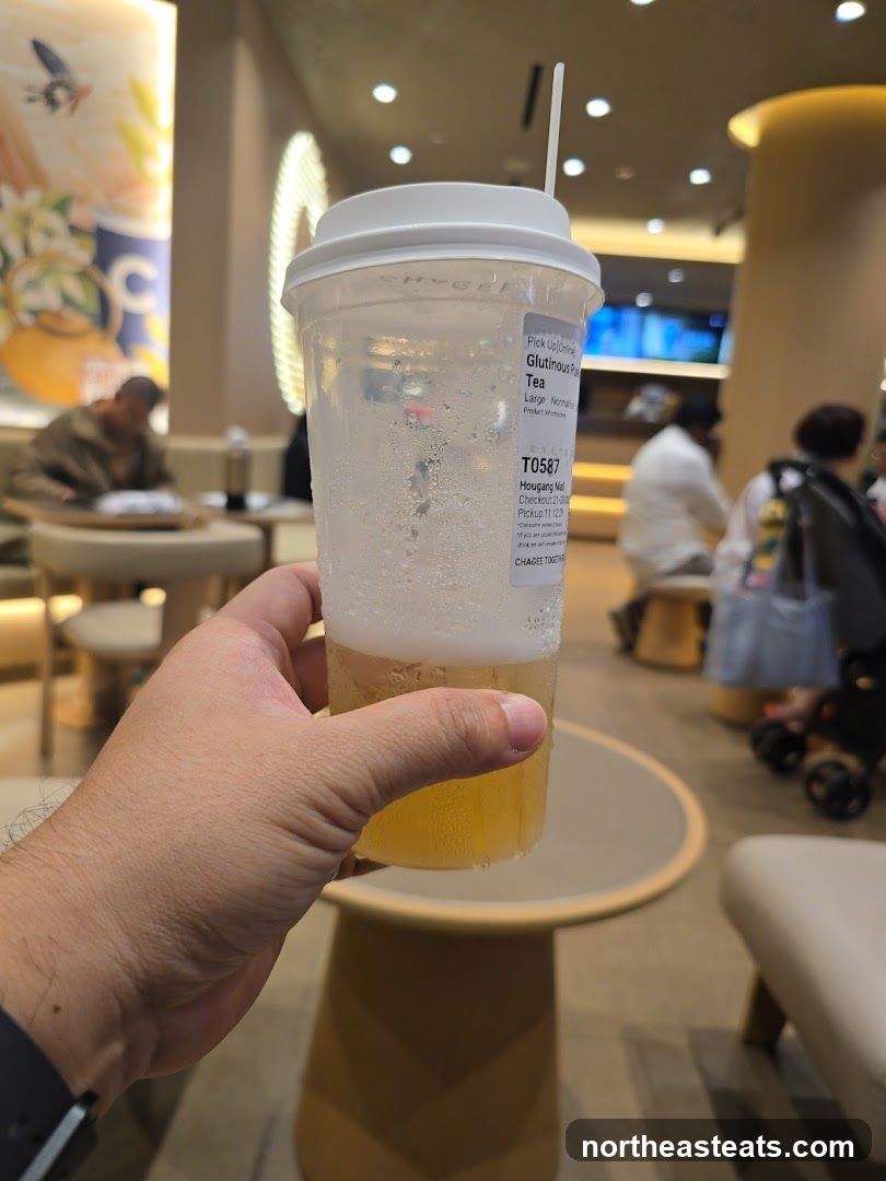 Hand holding a drink in a cafe