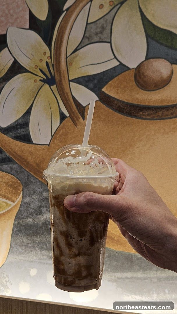 Hand holding a caramel frappe