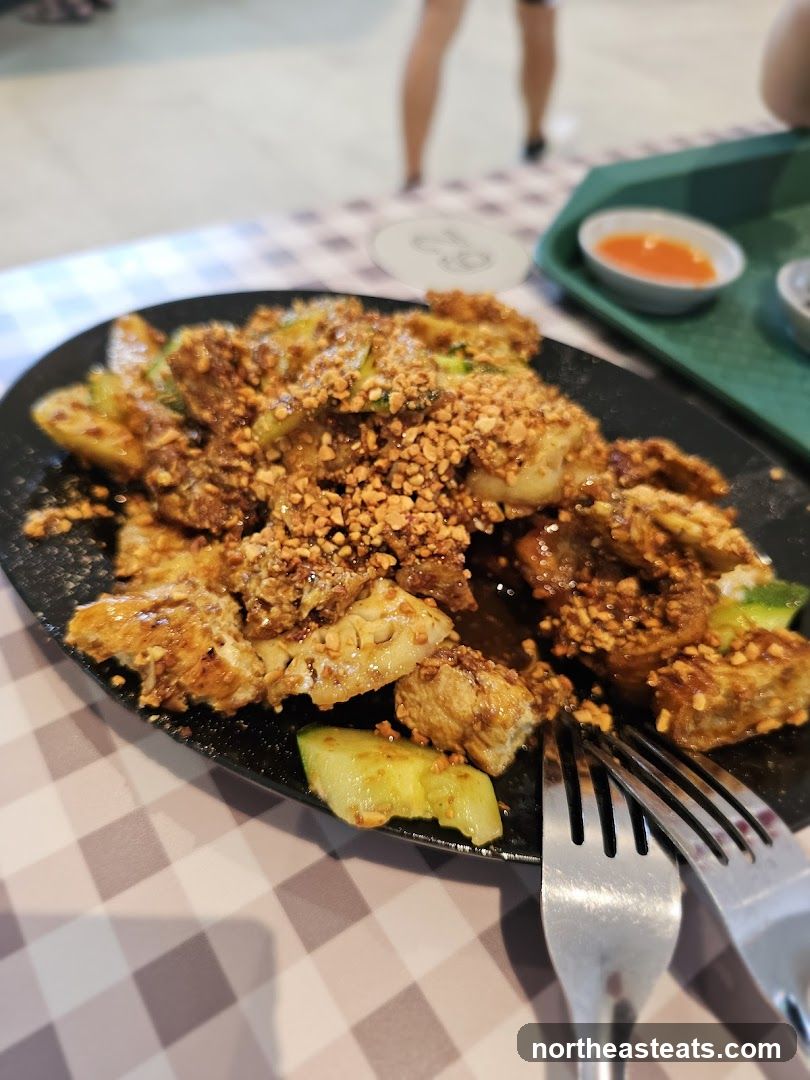 Plate of food with chopped nuts and cucumber