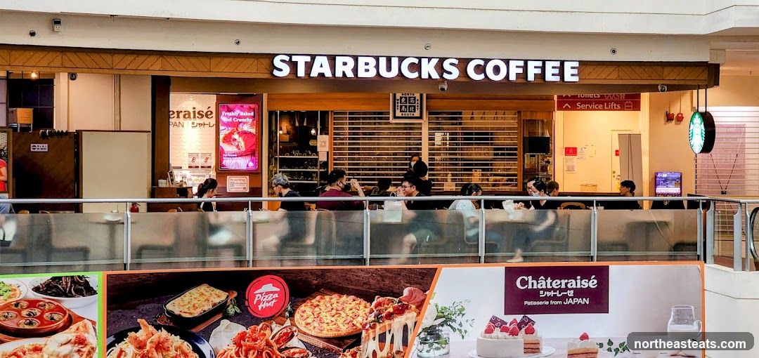 Starbucks Coffee Shop Front with Adjacent Advertisements
