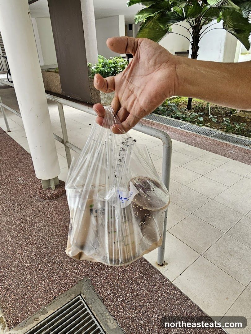 Hand holding a plastic bag of food