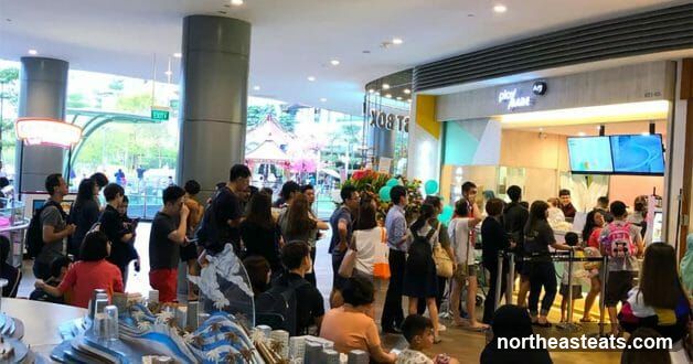 People Queueing at a Store