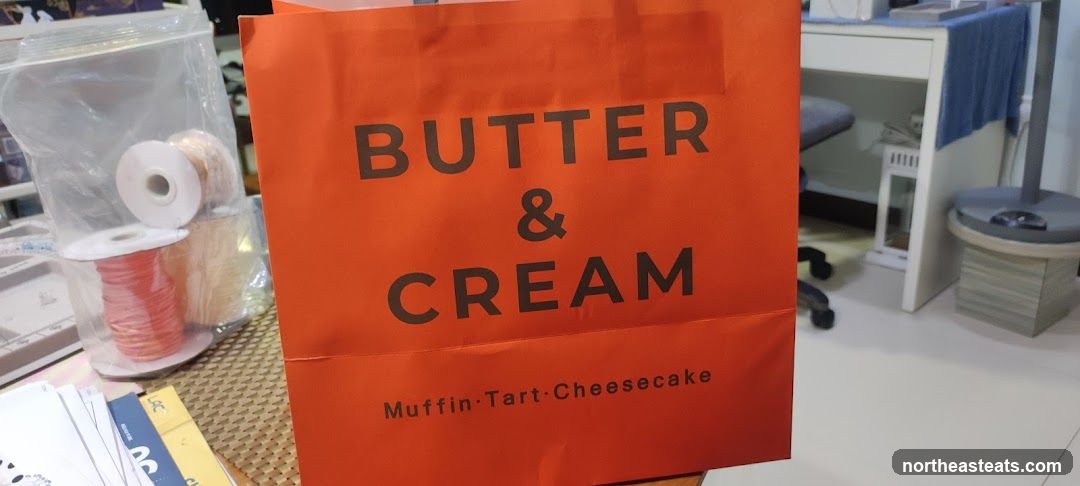 Orange shopping bag with "BUTTER & CREAM" logo