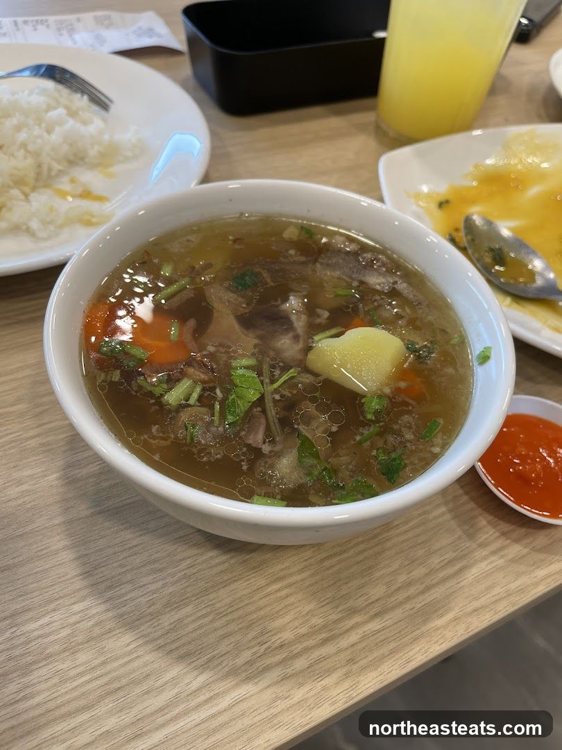 Bowl of Soup with Rice and Drink