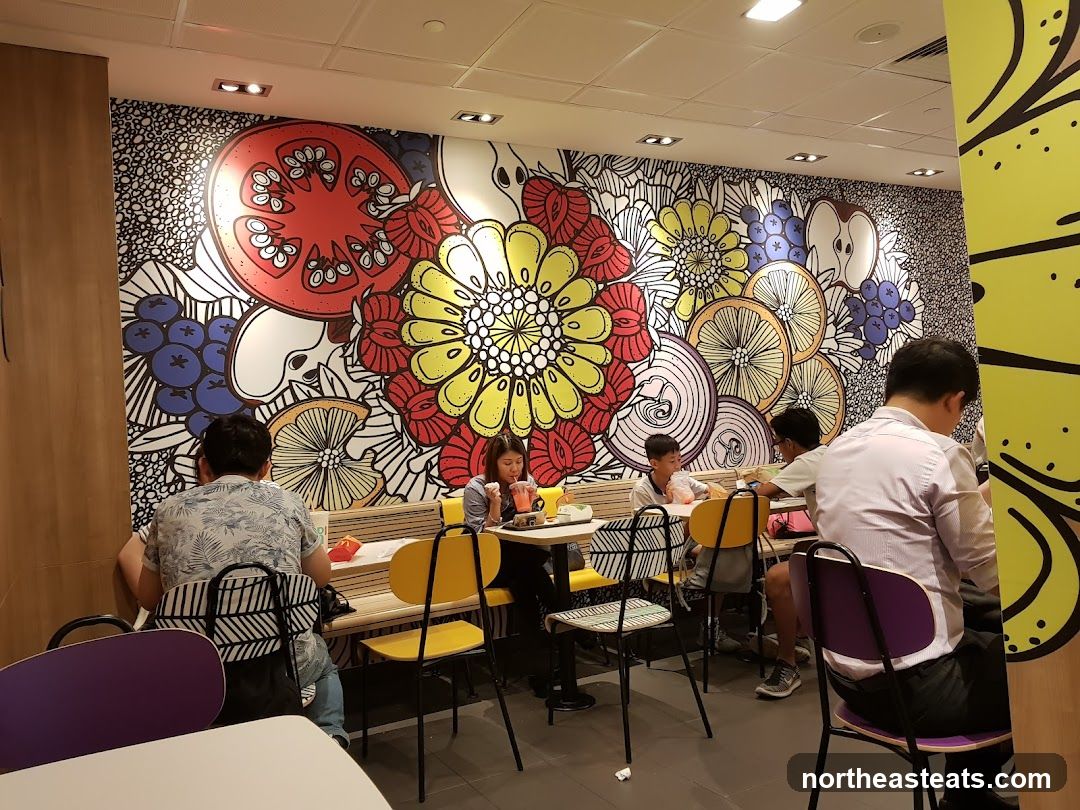Diners in a restaurant with a colorful mural