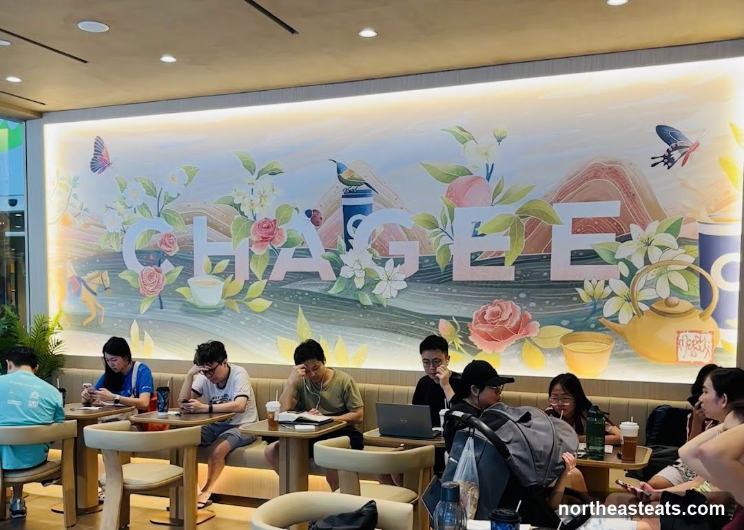 People in a cafe with a mural