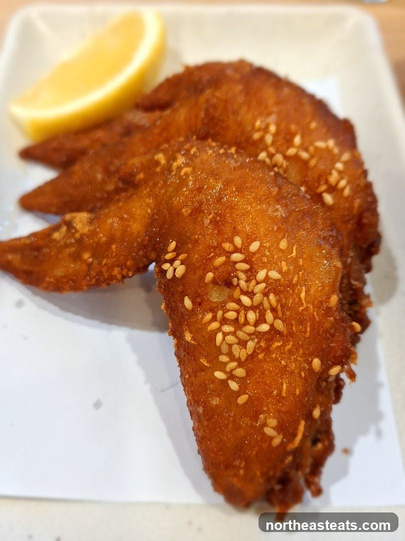 Fried Chicken Wings with Sesame Seeds and Lemon Wedge