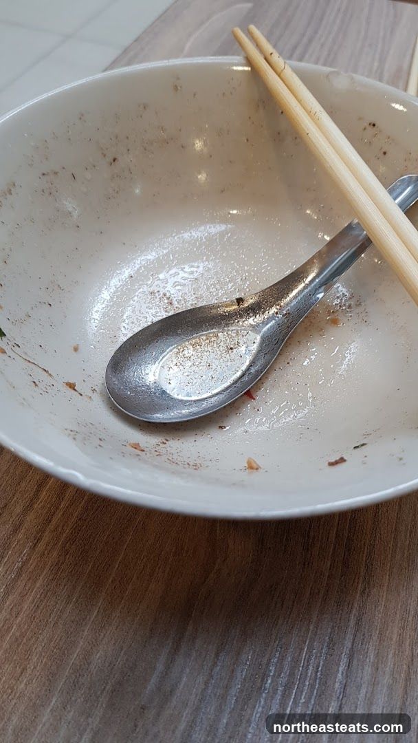 Dirty bowl with chopsticks and spoon