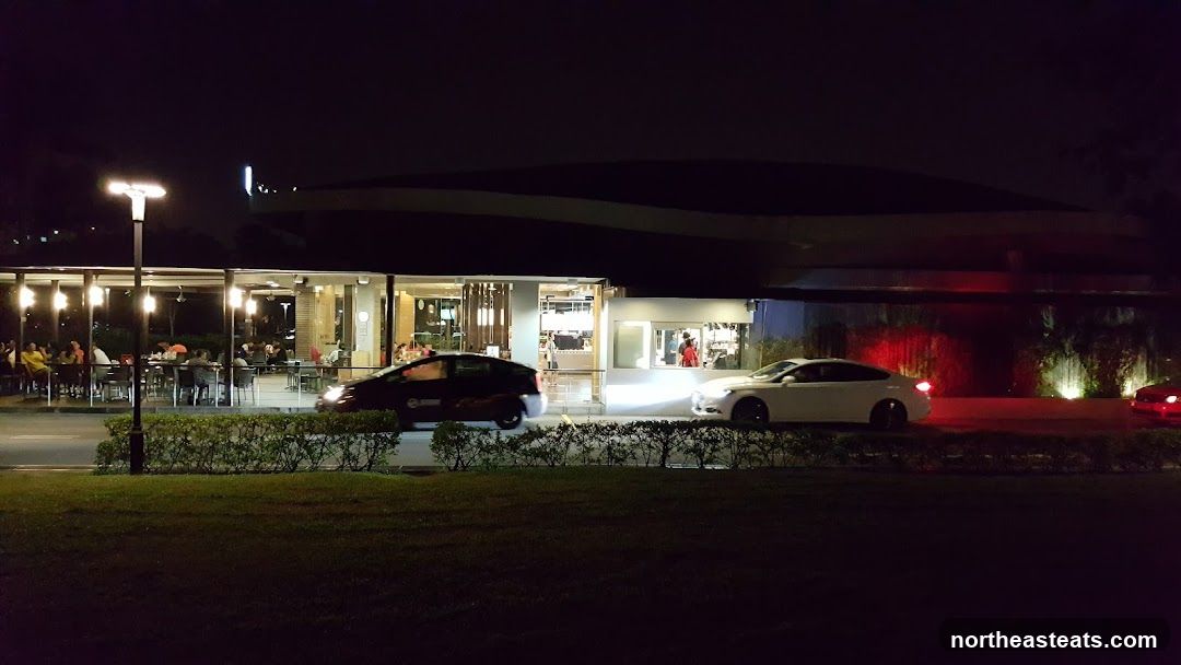 Nighttime view of a restaurant with outdoor seating