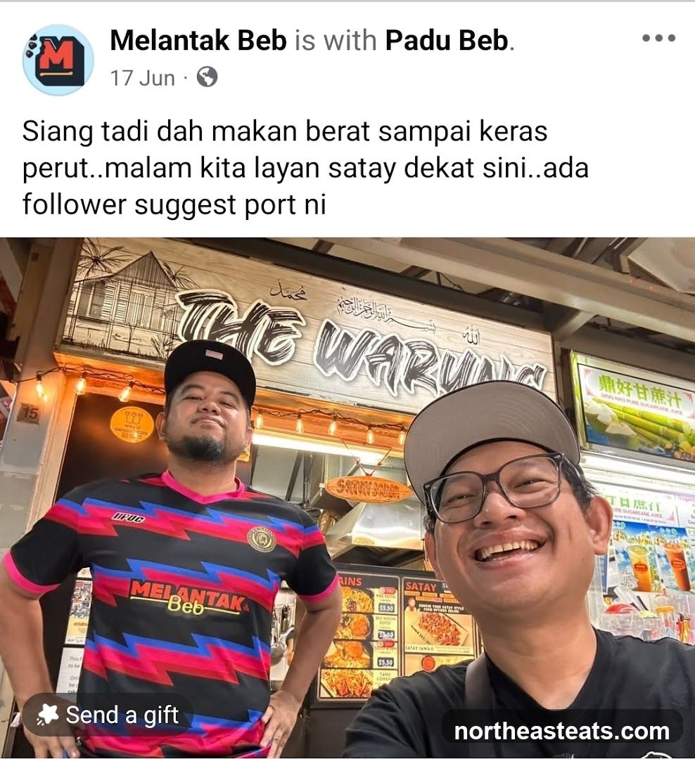 Two men in front of a food stall