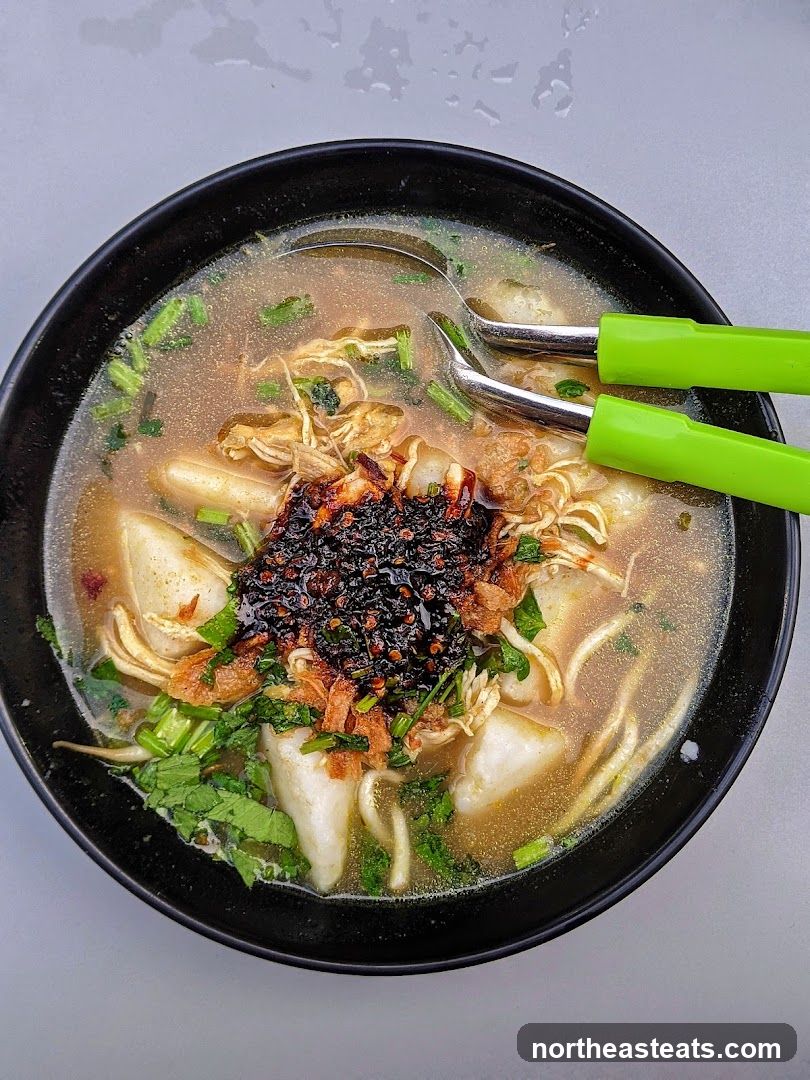 Bowl of Soup with Shredded Chicken and Chili Paste