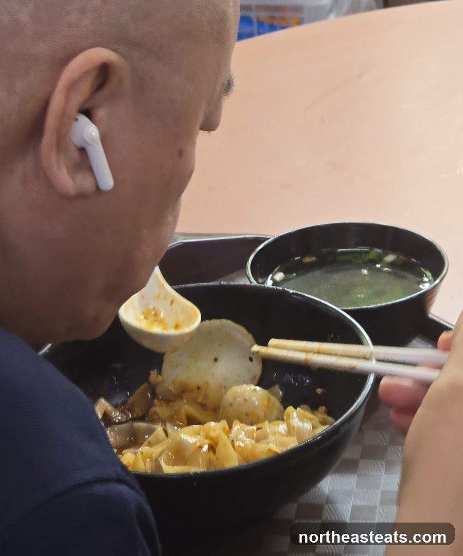 Person eating noodles