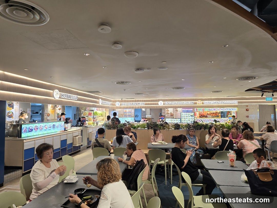 Food court with various stalls and diners