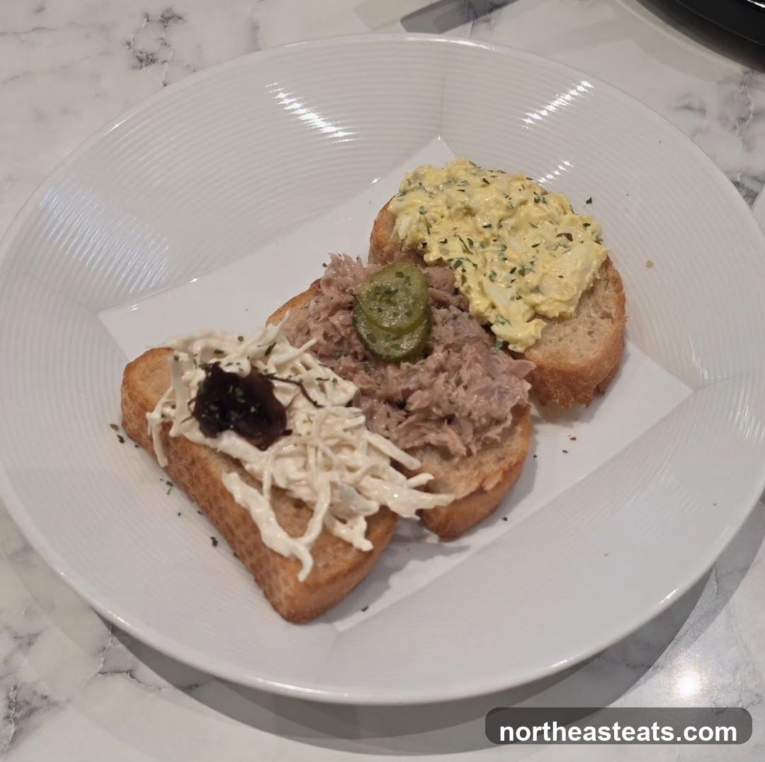 Three open-faced sandwiches on a white plate