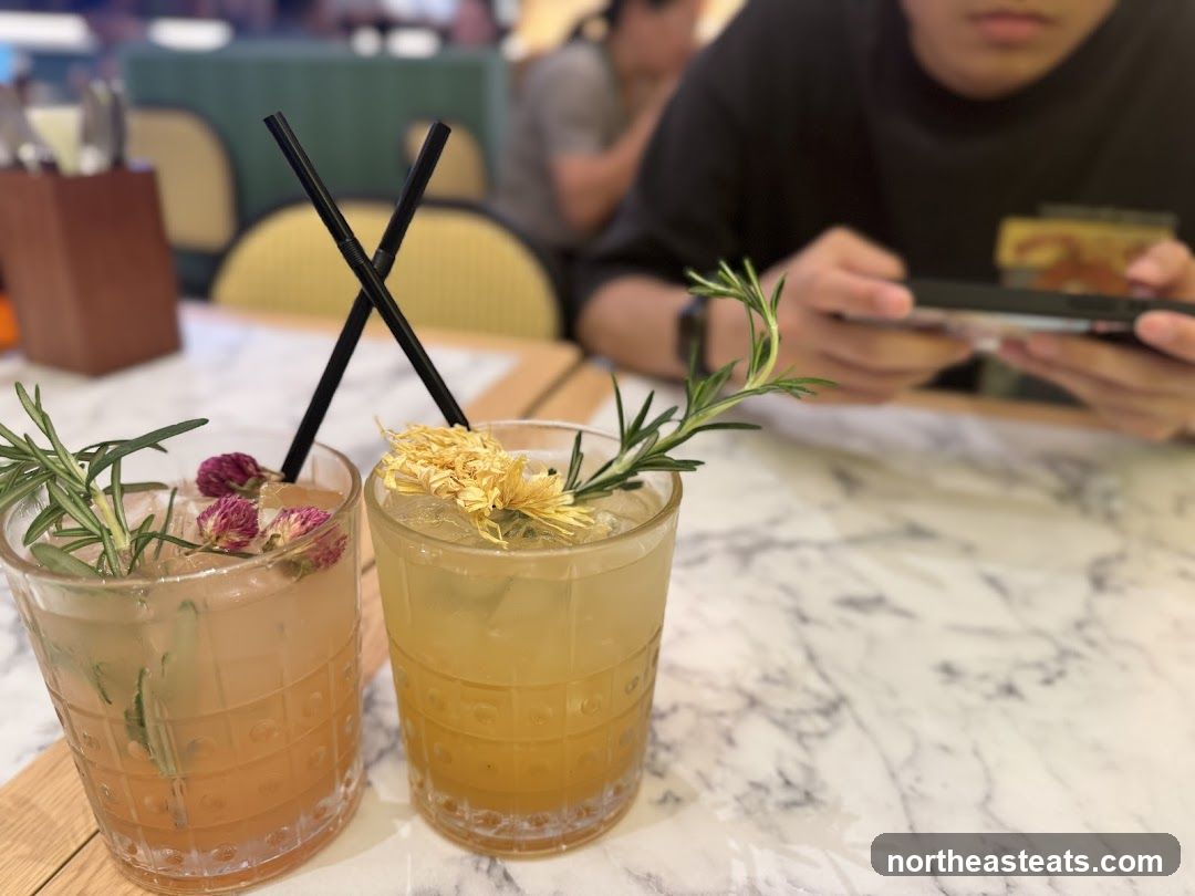 Two floral cocktails on a marble table