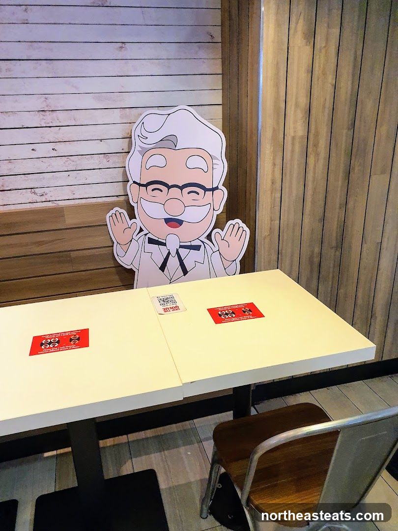 Colonel Sanders cutout at a table