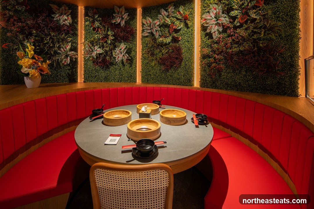 Restaurant Dining Area with Greenery and Red Booths