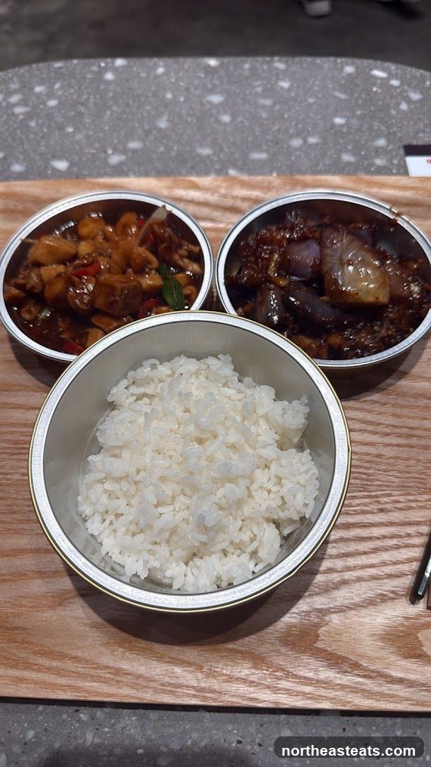Three bowls of food on a wooden tray