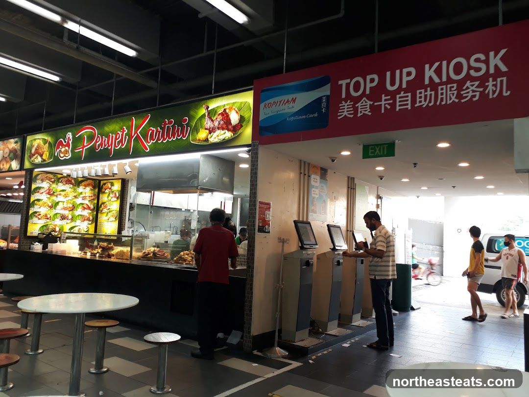 Food court with a food stall and top-up kiosks