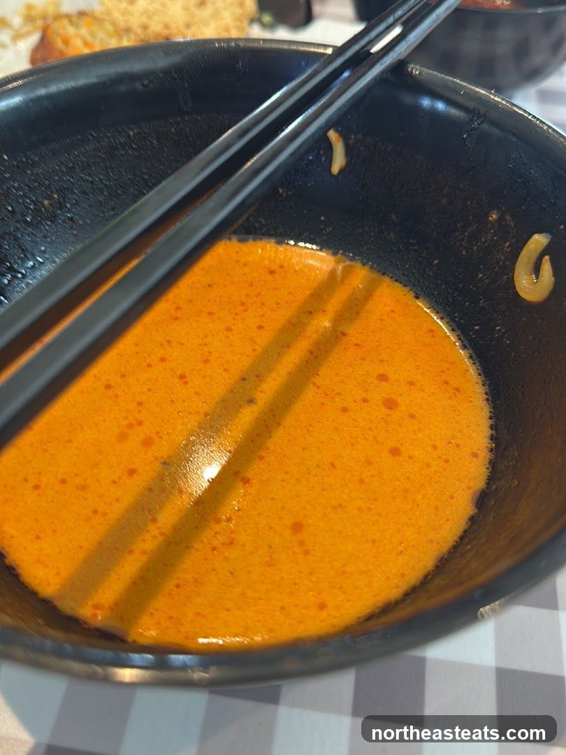 Close-up of a bowl of soup with chopsticks
