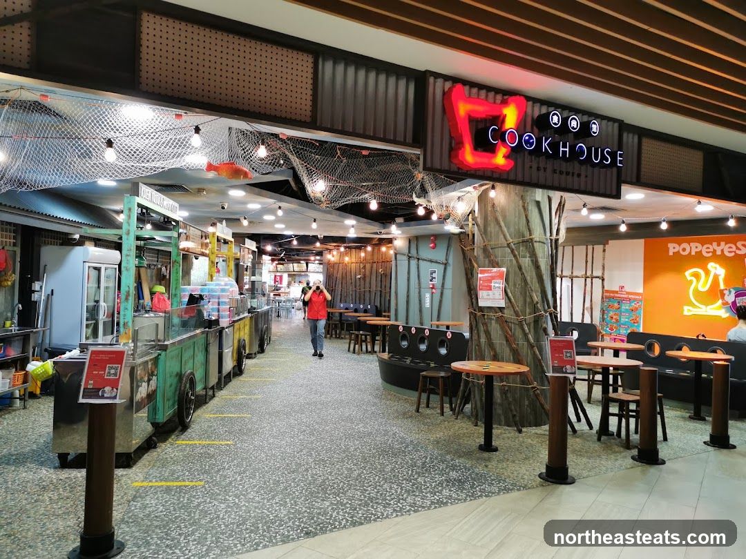 Food court with various stalls and seating areas