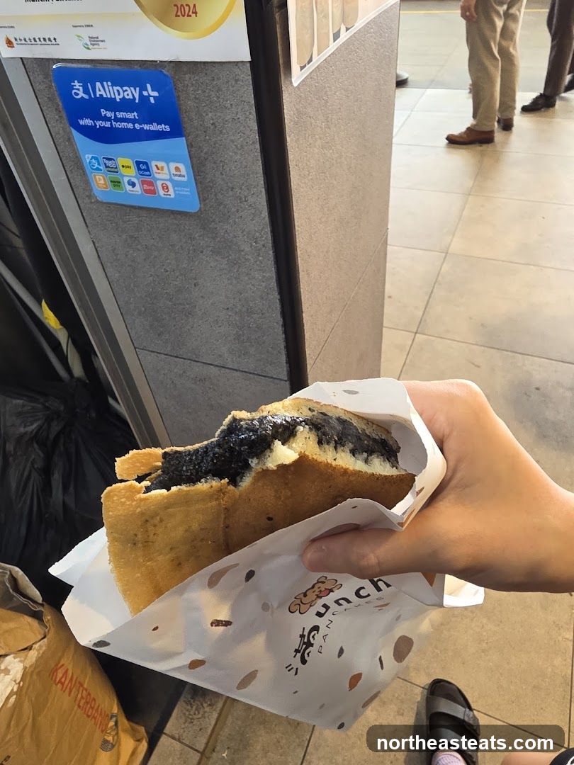 Person holding a pancake with black sesame filling