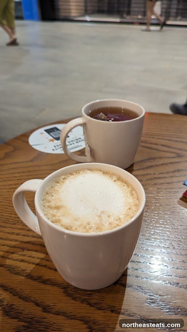 Two Mugs of Beverages on a Wooden Table