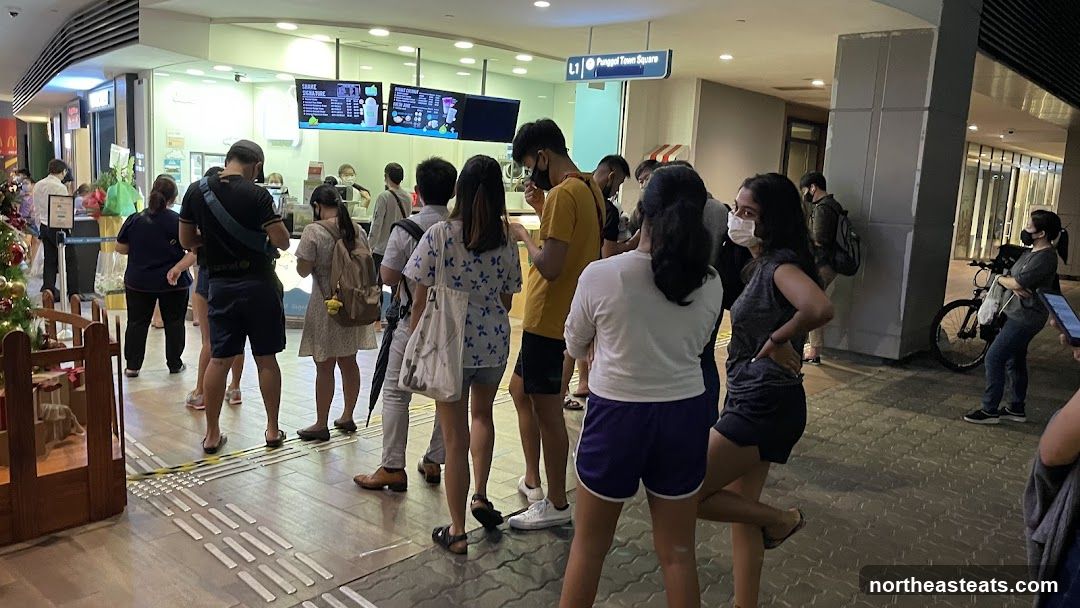 People queuing at a food stall