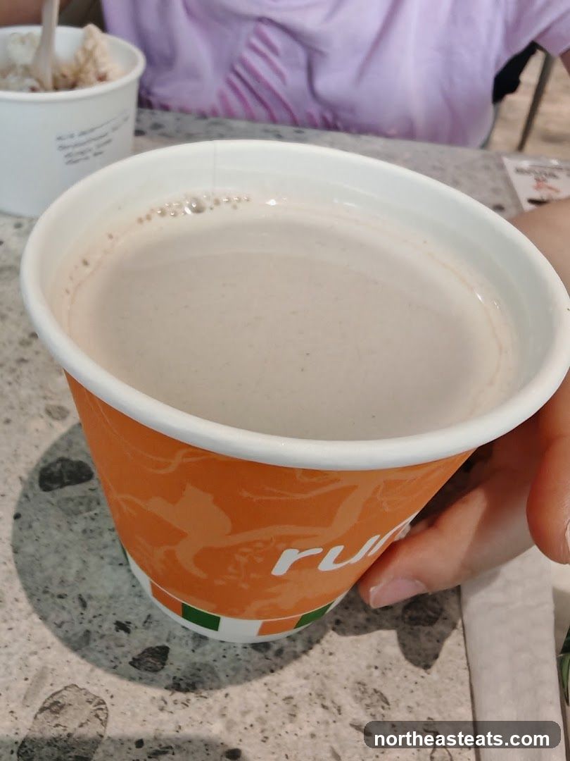 Beverage in a branded cup