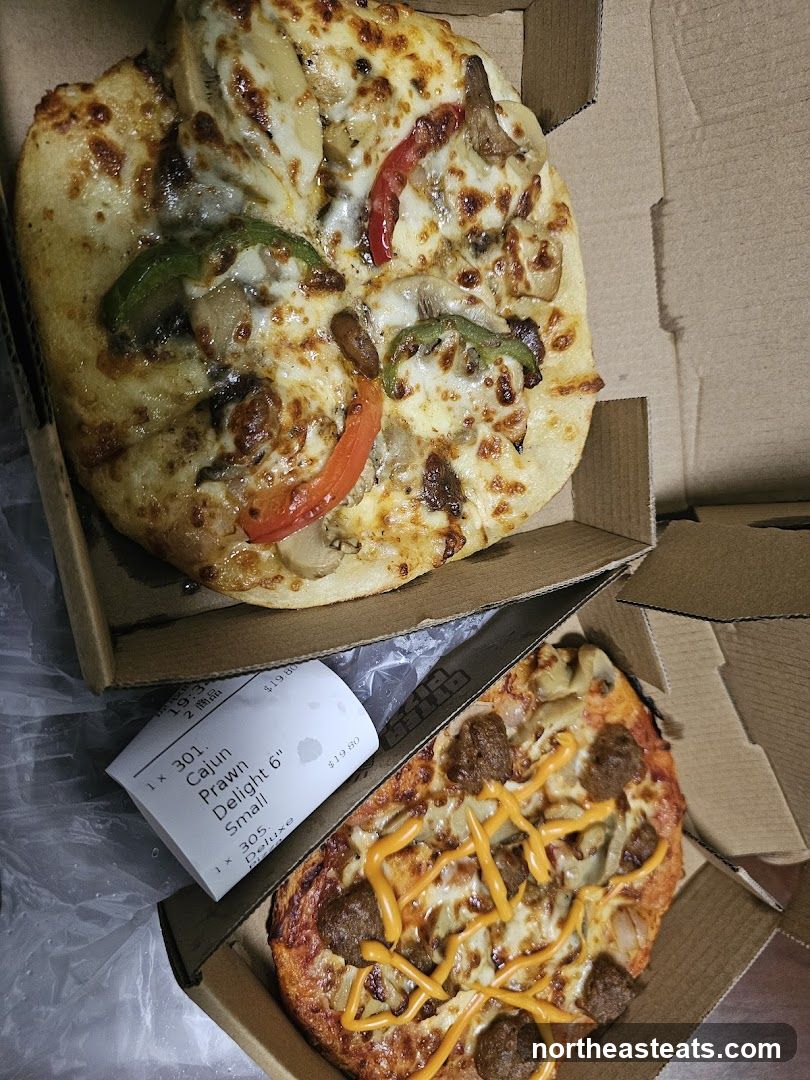 Two pizzas in boxes with a receipt