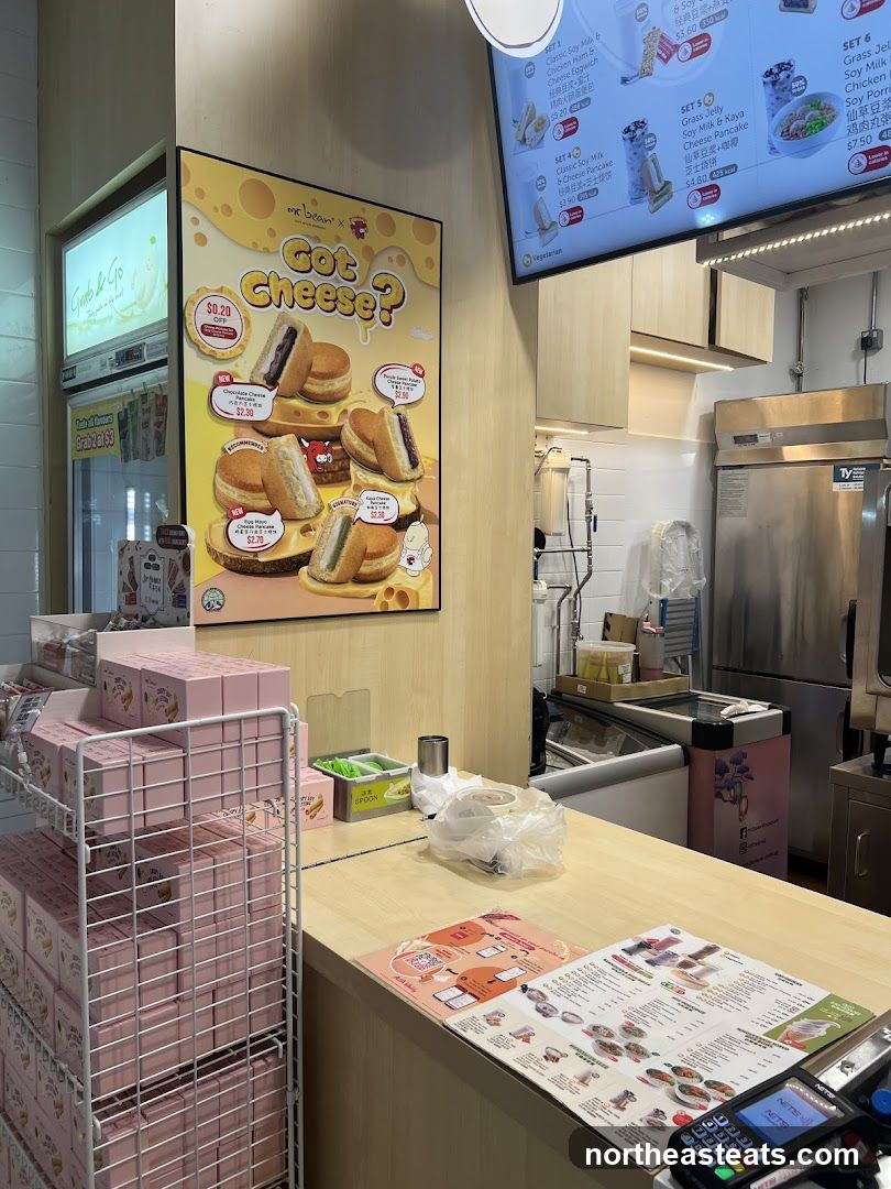 Food stall counter with promotional posters and menu