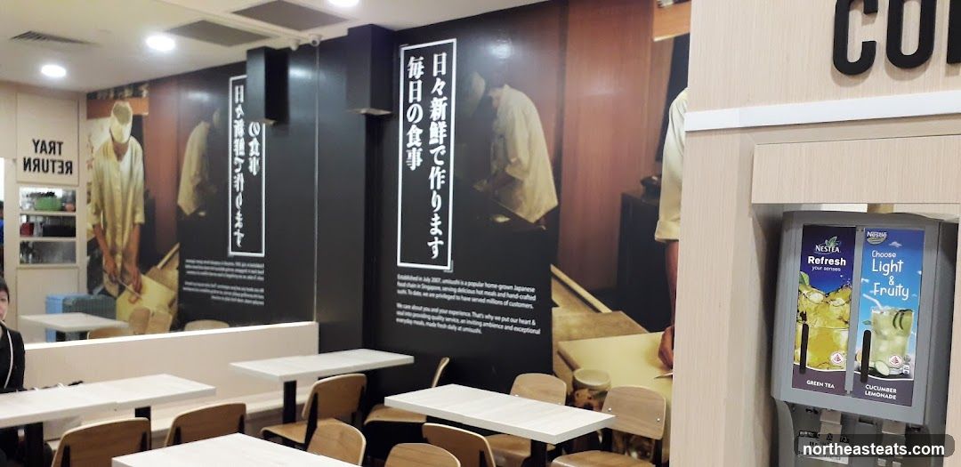 Restaurant Interior with Japanese Themed Wall Art and Drink Dispenser