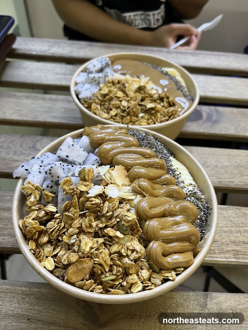 Two smoothie bowls with toppings