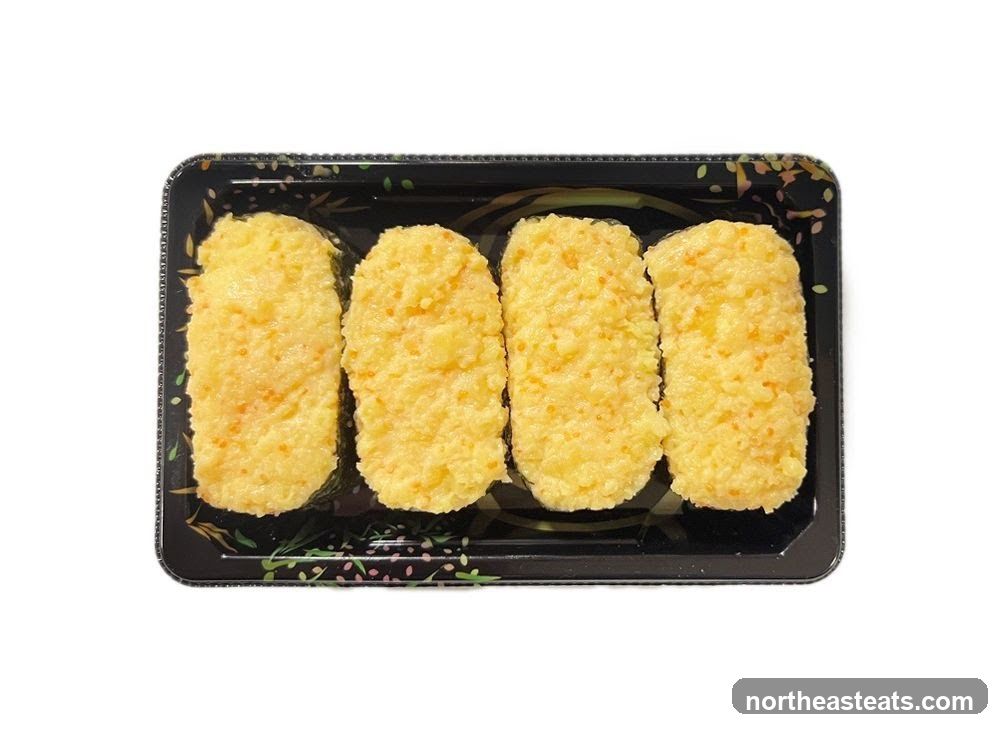 Four pieces of sushi in a black tray