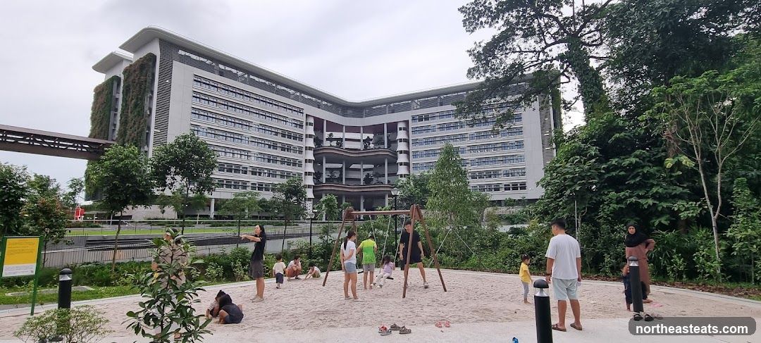 People at a Playground with a Modern Building