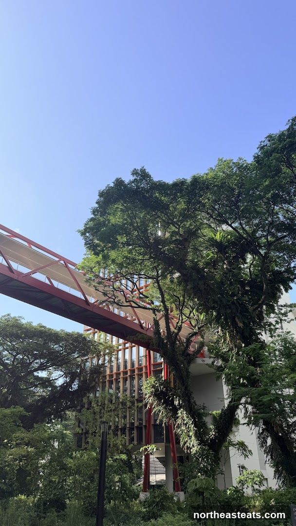 Modern Building with Skybridge and Lush Vegetation