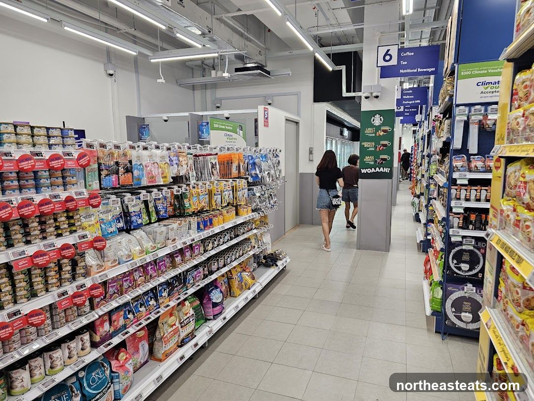 Aisle in a store with shelves stocked with pet food and other products.