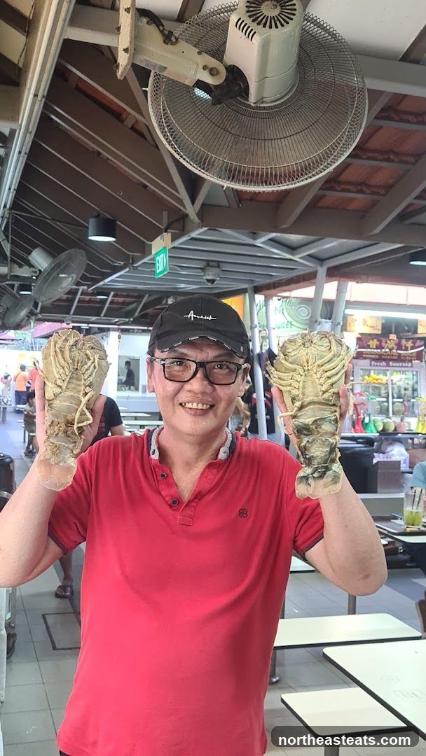 Man holding two slipper lobsters